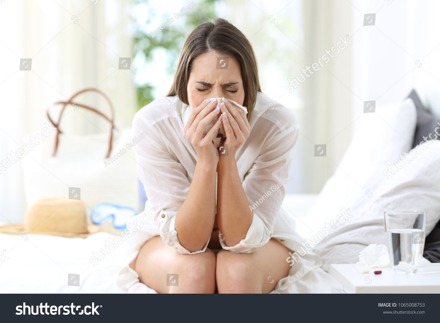stock-photo-ill-woman-coughing-in-an-hotel-room-on-summer-vacations-on-the-beach-1065008753